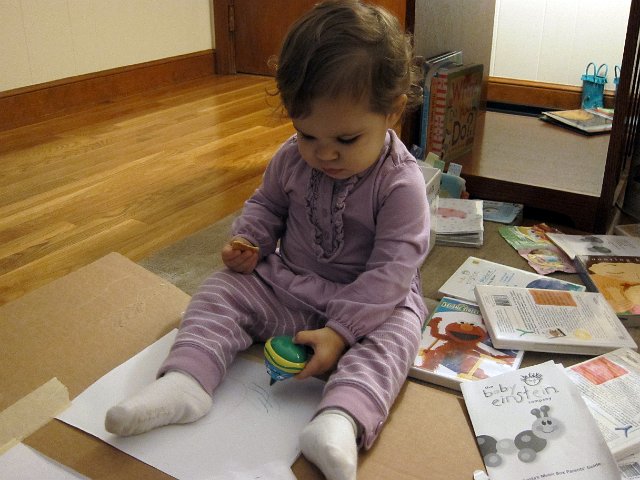 IMG_0542b.jpg - Her first masterpiece ... crayon and cracker in each hand!
