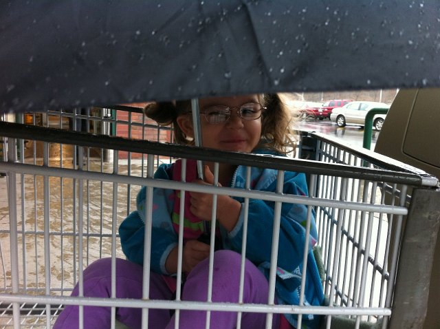 IMG_1977.jpg - Our little princess is not a fan of the rain during a trip to the grocery store.