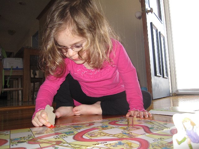 IMG_8504.jpg - Catherine is loving the chutes of Chutes and Ladders .. she'll eventually understand that going down the slide is not a good thing when playing this game.  For now, it's just fun!