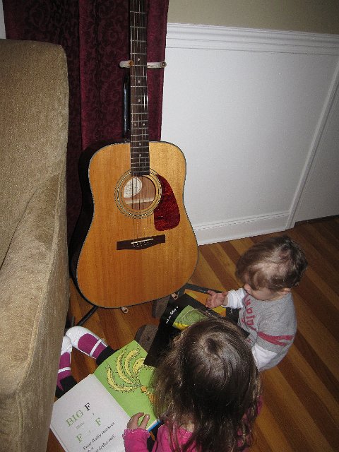 IMG_8510.jpg - Adorable moment … They play the guitar together while singing the alphabet and following along in alphabet-themed books.