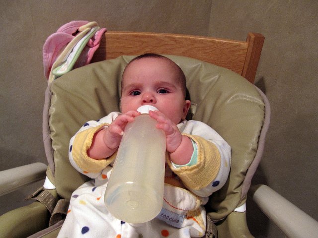 IMG_4585b.jpg - Catherine is getting closer to the point of holding her own bottle.  It's pretty easy in this instance because the bottle is all but empty.