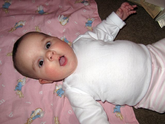 IMG_4113b.jpg - She rolls from belly to her back with greater ease and even she looks amazed at her accomplishment!