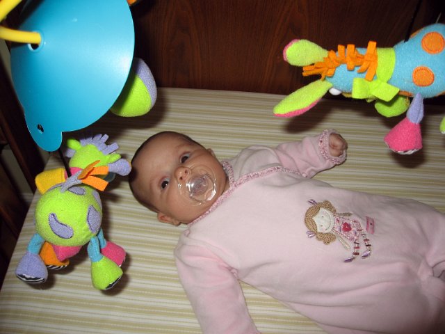 IMG_2872b.jpg - Catherine checking out the mobile in her crib.
