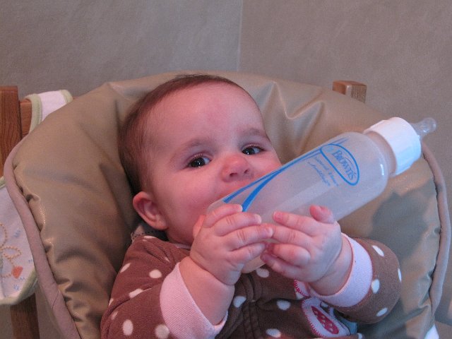 IMG_6506.JPG - Trying to get the hang of holding her own bottle ...