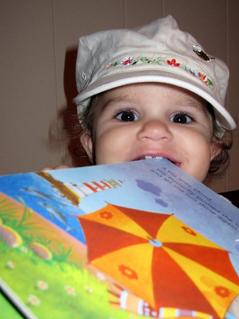 IMG_0336b.jpg - Catherine with one of her new favorite books (in her mouth)!