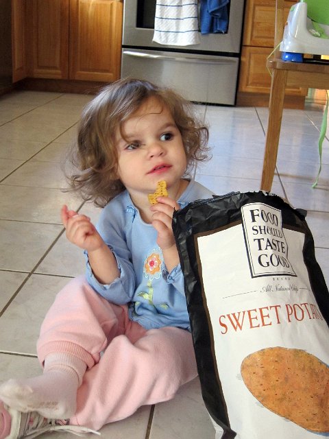 IMG_2525b.jpg - I thought she'd make a terrific commercial spokesperson for one of her favorite chips.  Although, the bag is almost as big as she is.