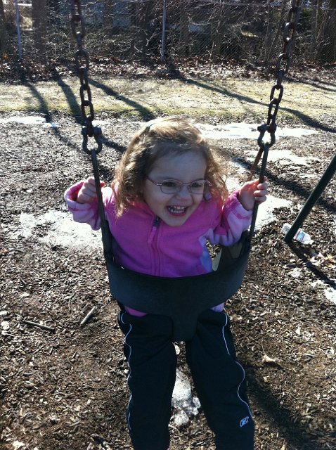 1000000366b.jpg - We headed to the playground even though there was still snow on the ground.   I think Catherine wishes she could swing ALL DAY!