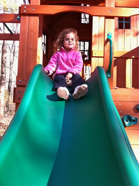 IMG_1679.jpg - Catherine "riding" Charlie down the slide â¦ poor, poor puppy.