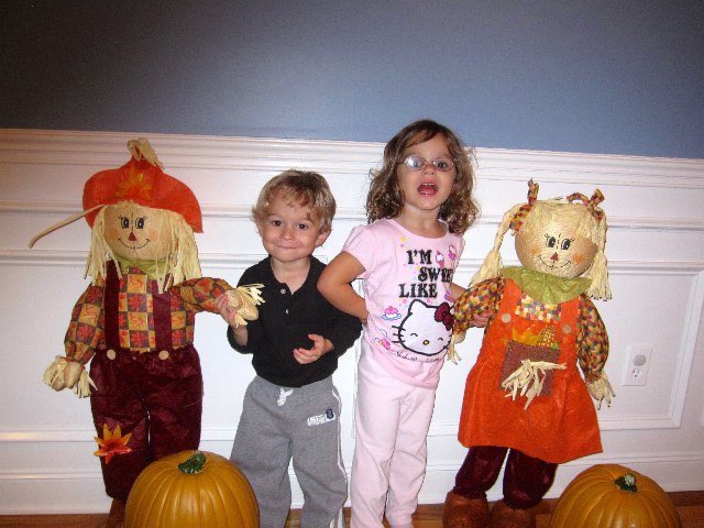 IMG_2715.jpg - Our kiddos among their scarecrow friends .. they're almost the same size!