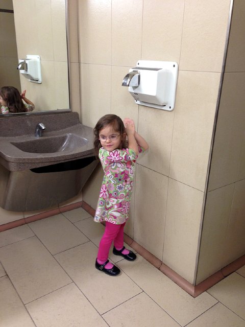 IMG_3184.jpg - Catie Ann loves it when a public restroom has an air hand dryer.  Although looking at her height, I'm not sure why she likes it so much!