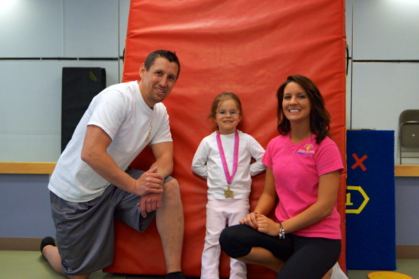 burkett.jpg - Catie Ann wrapping up another round of Sports Tumble at Ready, Set, Go with Mr. Steve and Miss Becky.