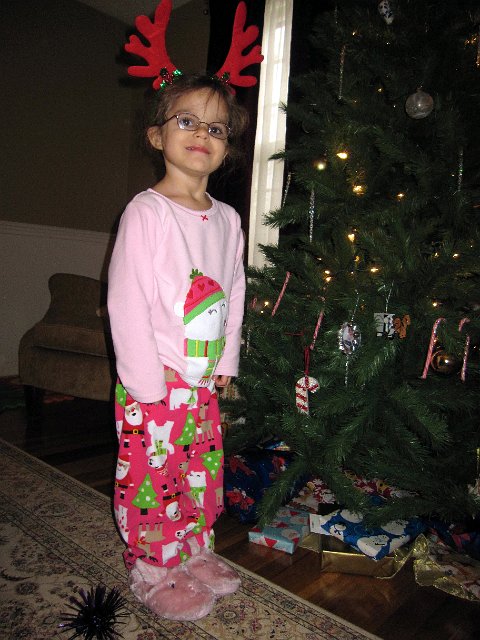 IMG_3408.jpg - Inside the pink wrapping were her pink bunny slippers.  (And she received a Rudolph PEZ dispenser in her stocking.)